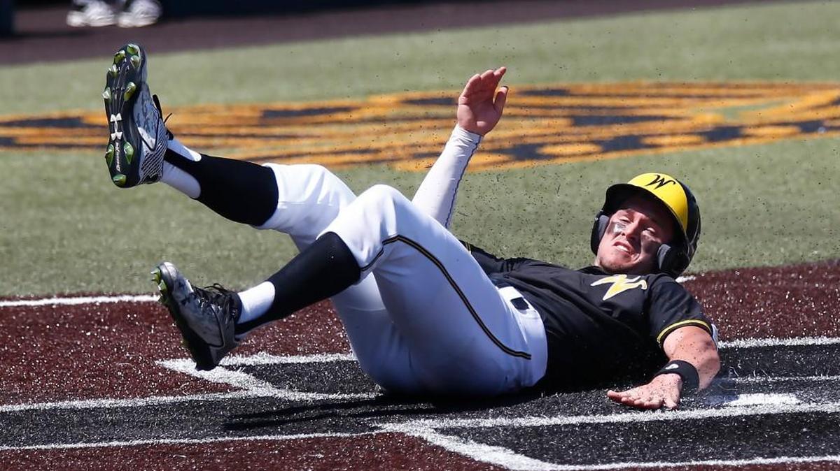 Wichita State's Travis Young slides safely home in the fifth inning to score the Shockers' first run against Bradley earlier this season.