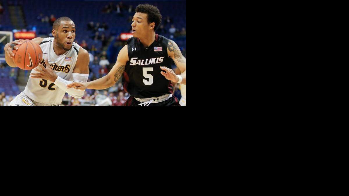 
Wichita State guard Tekele Cotton drives to the basket against Southern Illinois guard Deion Lavender during the second half of their quarterfinal game at the Scottrade Center in St. Louis on Friday.
