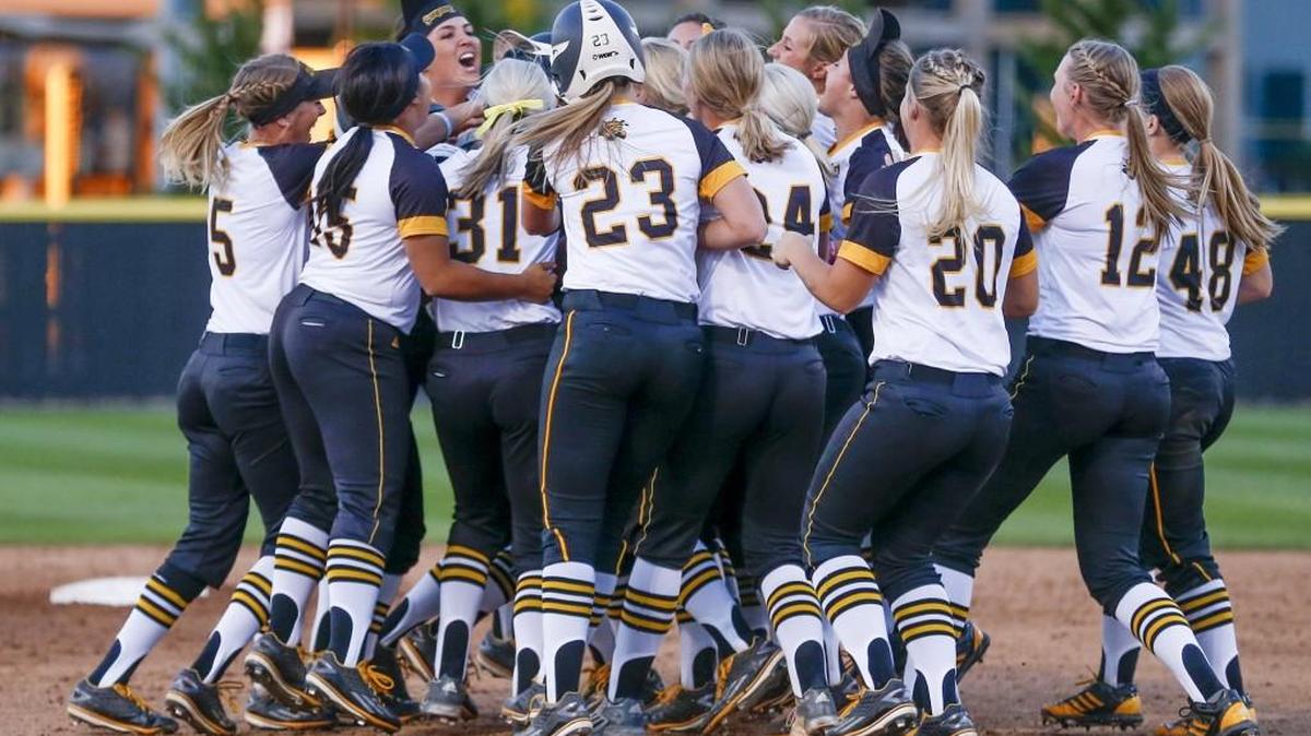 The Wichita State softball team rushes out to congratulate Kelli Spring after her game-winning hit in the bottom of the seventh helped beat Missouri State 5-4 at Wilkins Stadium on Tuesday.