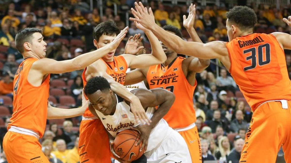 Wichita State’s Darral Willis is surrounded by Oklahoma State defenders in the Cowboys’ 93-76 victory Saturday night at Intrust Bank Arena.