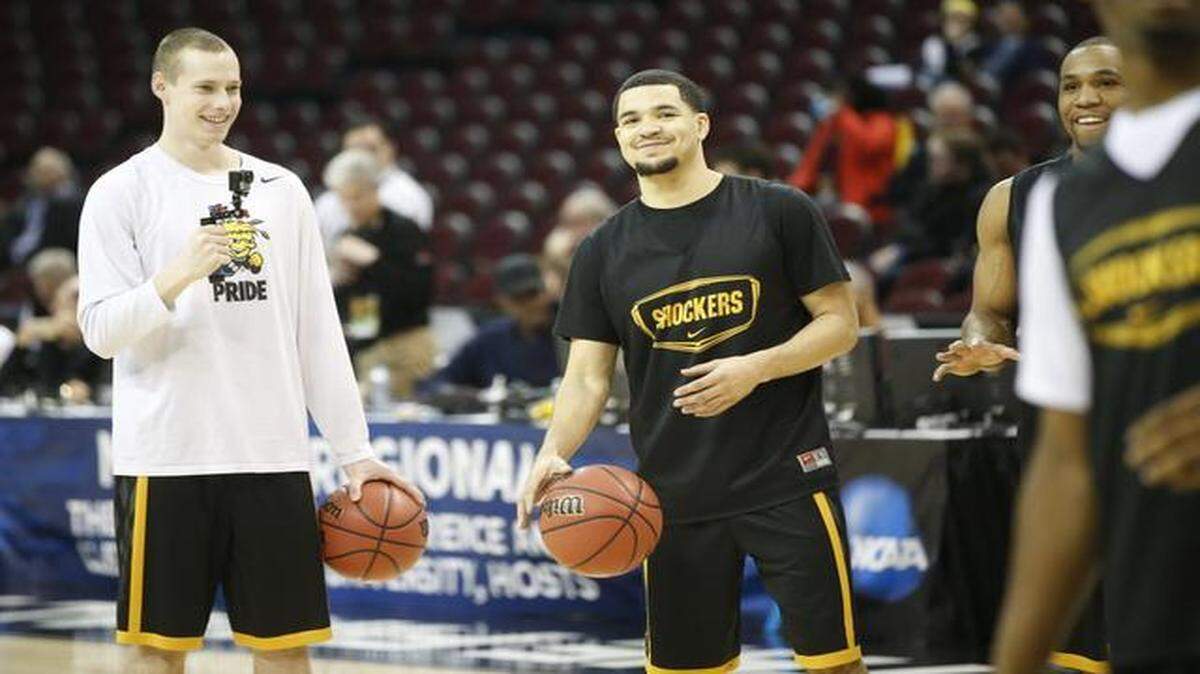 
Zach Bush and Fred VanVleet laugh during the Shockers’ public practice Wednesday at Quicken Loans Arena.
