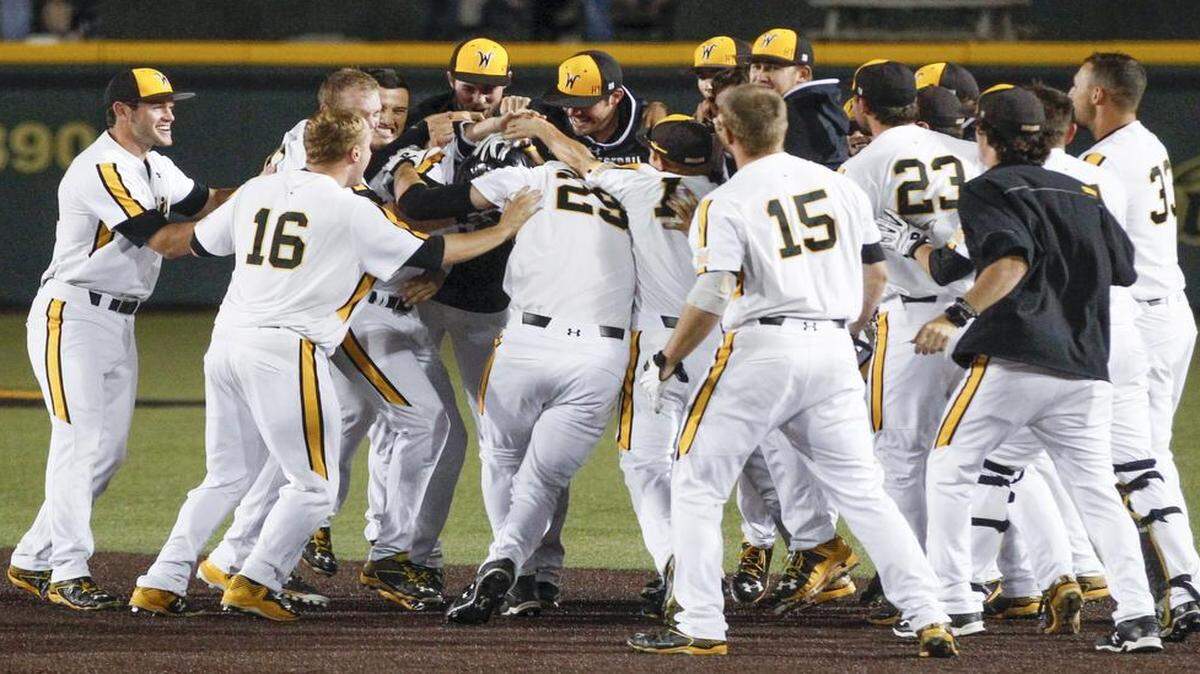 
The Wichita State baseball team comes out to congratulate Mikel Mucha after his line drive to bring in the winning run against New Mexico in the bottom of the ninth inning Friday at Eck Stadium.
