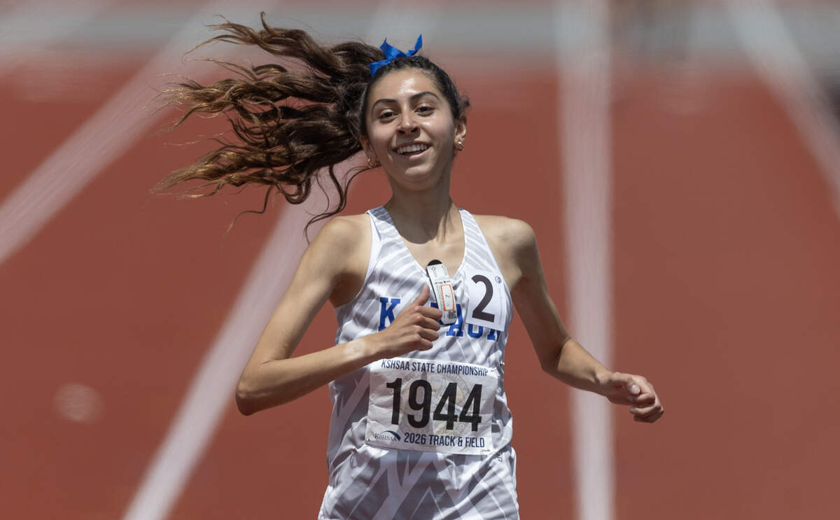 Kapaun Mt. Carmel sophomore Ava Claassen smiles as she crosses the finish line to win the Class 5A 1,600-meter title at the Kansas high school state track and field championships at Crossland Stadium in Wichita.