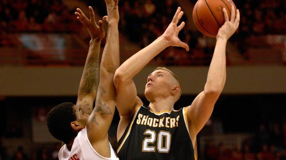 Wichita State center Rauno Nurger (20) drives on Illinois State forward Deontae Hawkins (23) during first half action Saturday at Redbird Arena.