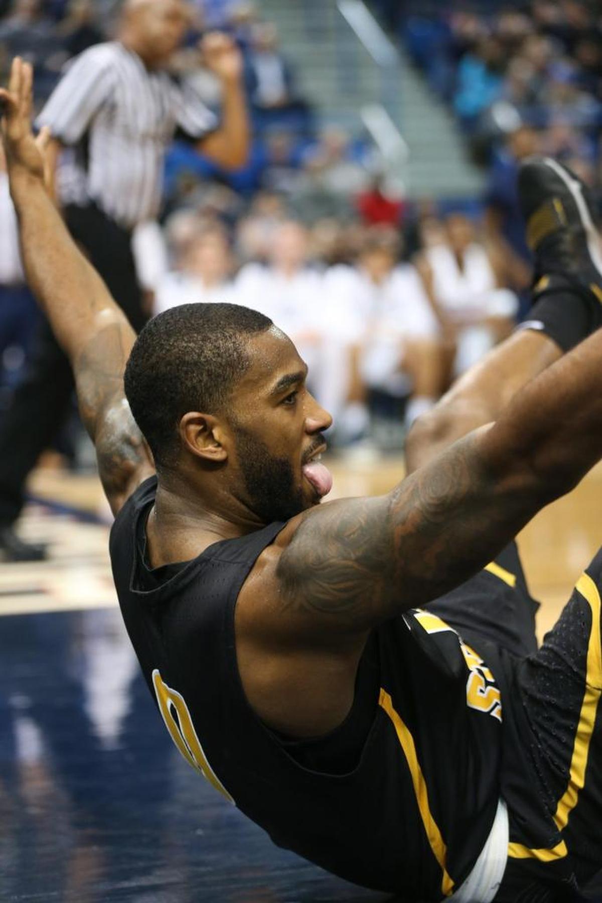 Rashard Kelly falls to the ground after he was fouled during the game against Connecticut on Dec. 30.