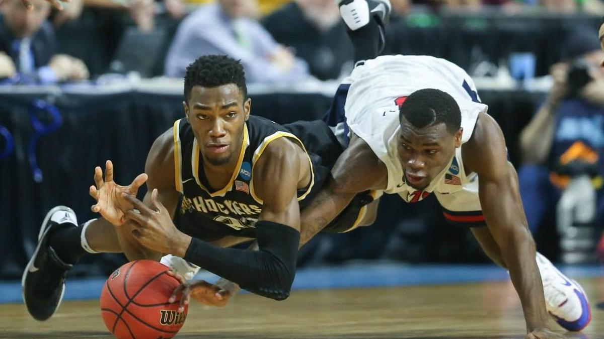 Wichita State forward Markis McDuffie and Arizona guard Kadeem Allen dive for a loose ball during the first half at Dunkin Donuts Arena in Providence, R.I., in March.