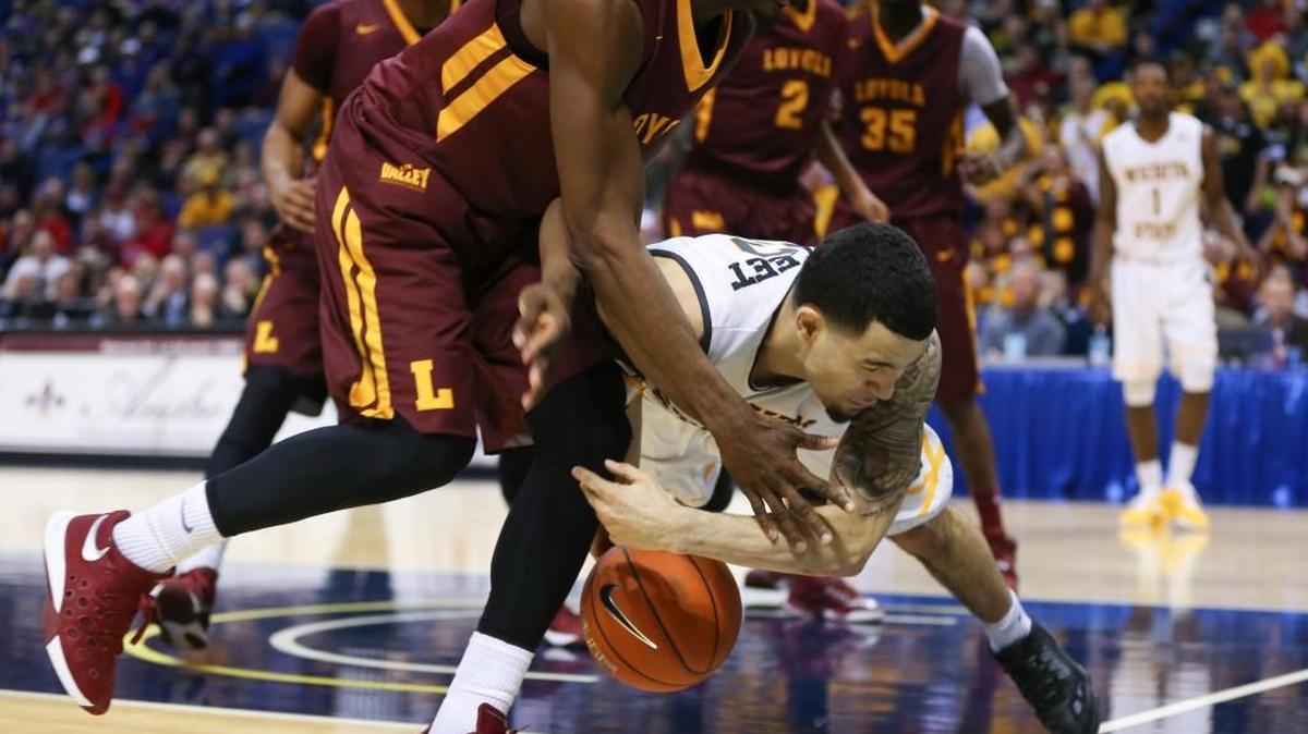 Wichita State guard Fred VanVleet dives for a loose ball against Loyola guard Devon Turk.