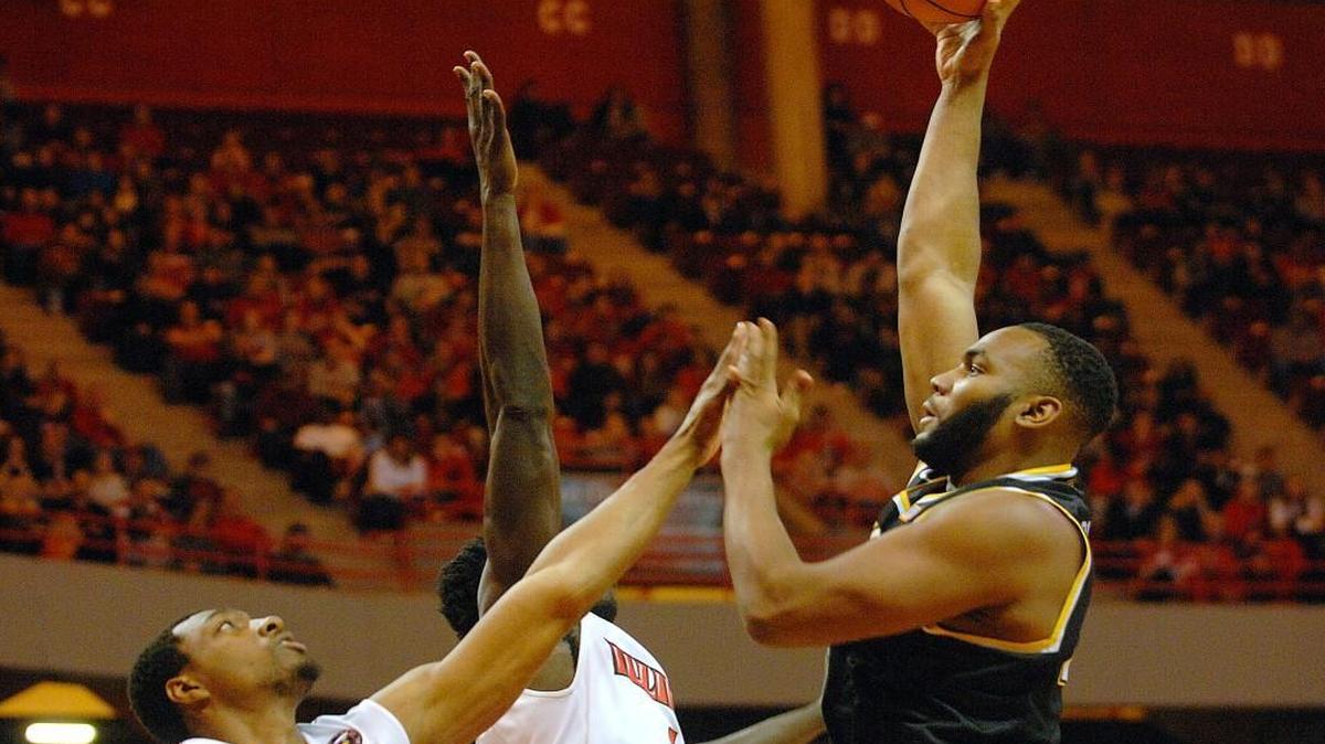 Wichita State center Shaquille Morris (24) shoots over Illinois State forward MiKyle McIntosh (11) and guard Paris Lee (1) during first-half action Saturday at Redbird Arena.