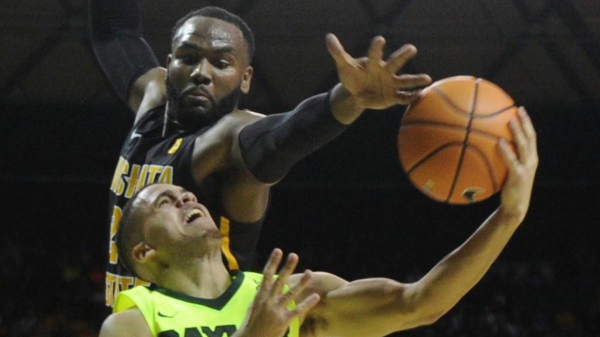 Wichita State center Shaquille Morris (24) pressures Baylor guard Manu Lecomte (20) on a shot in the second half Saturday in the Shocker victory.