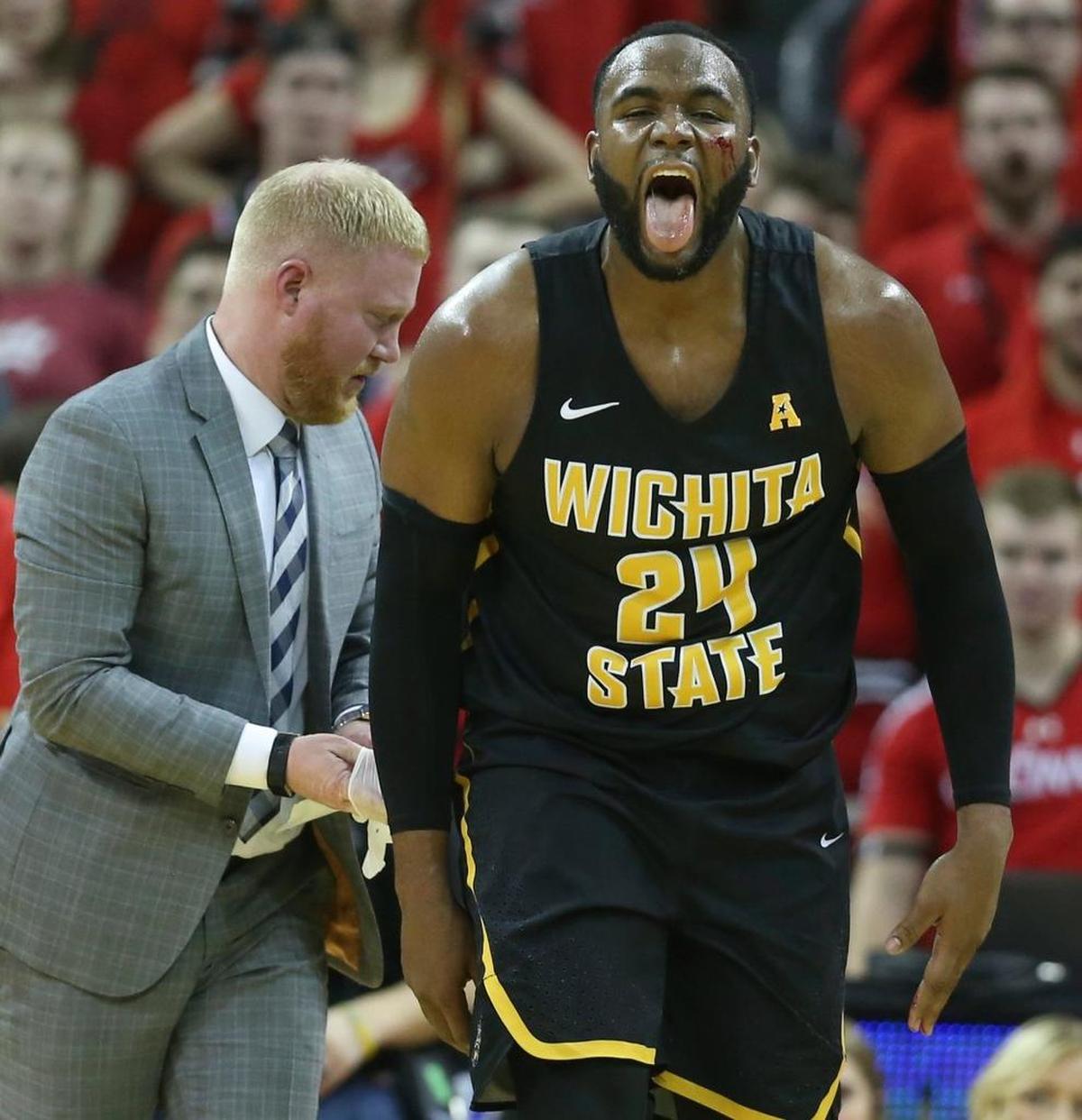 Wichita State center Shaquille Morris gets up off the court after cutting his face on a play during the second half Sunday at BB&T Arena in Highland Heights, Ky.