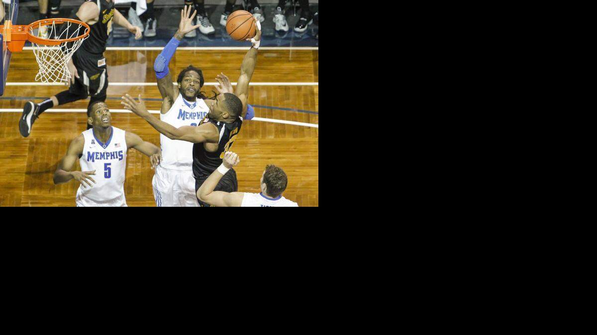 
Wichita State's Tekele Cotton throws down a huge dunk against Memphis' Shaq Goodwin during the second half at the Sanford Pentagon in Sioux Fall, S.D., on Tuesday.
