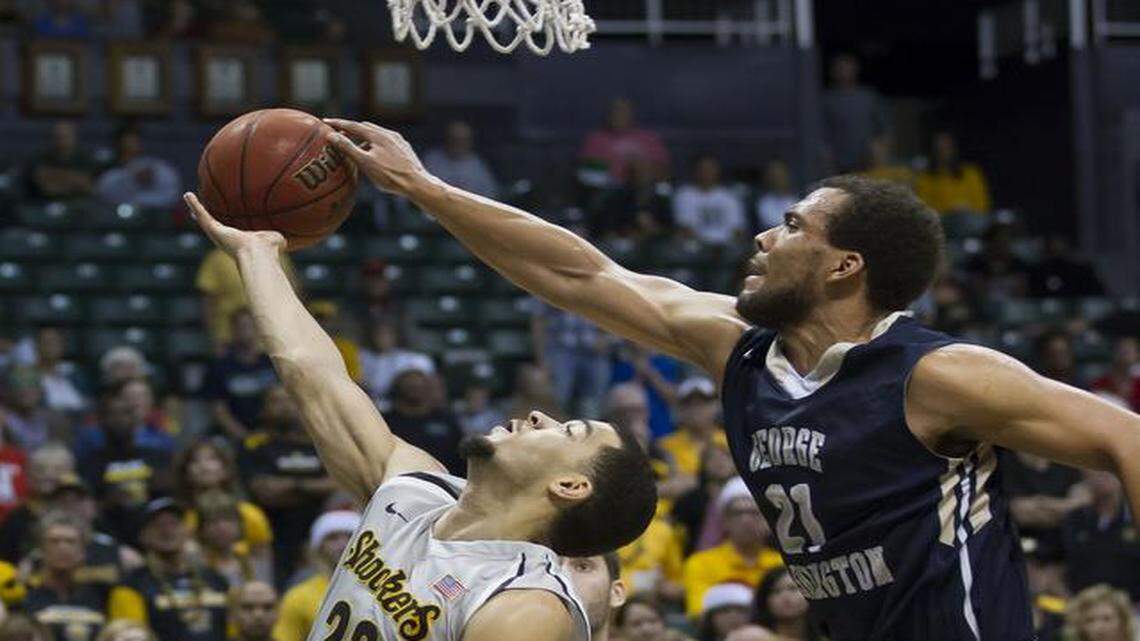 
George Washington forward Kevin Larsen (21) goes up to block a shot by Wichita State guard Fred VanVleet (23) in the second half of GW’s 60-54 win on Christmas Day.
