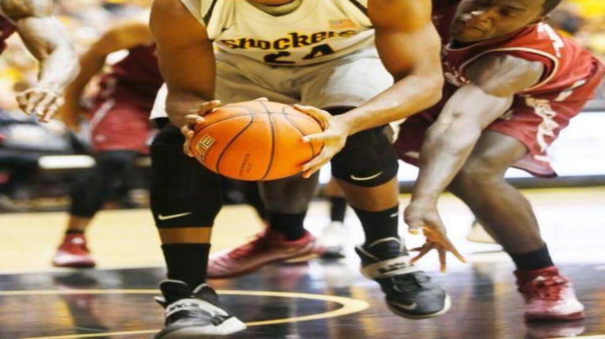 
Wichita State's Shaquille Morris (24) grabs a rebound in the first half against New Mexico State.

