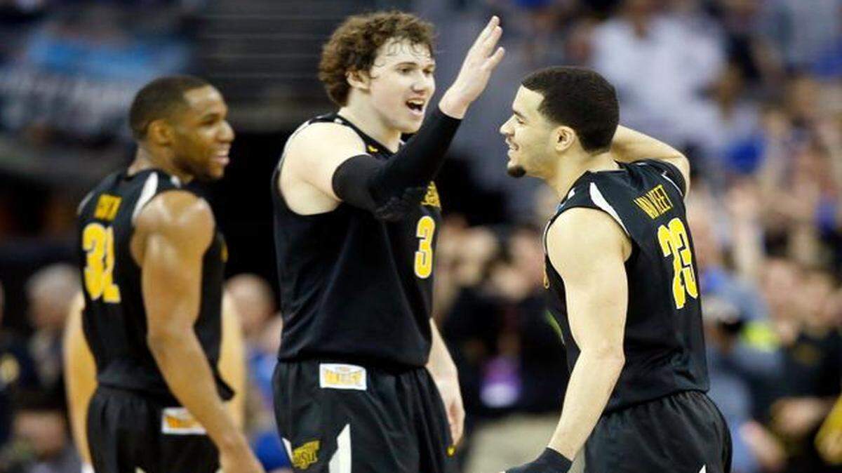 
Wichita State guard Fred VanVleet, right, gets a high-five from teammate Evan Wessel in the final seconds of their win over Kansas in the NCAA Tournament at CenturyLink Center in Omaha.
