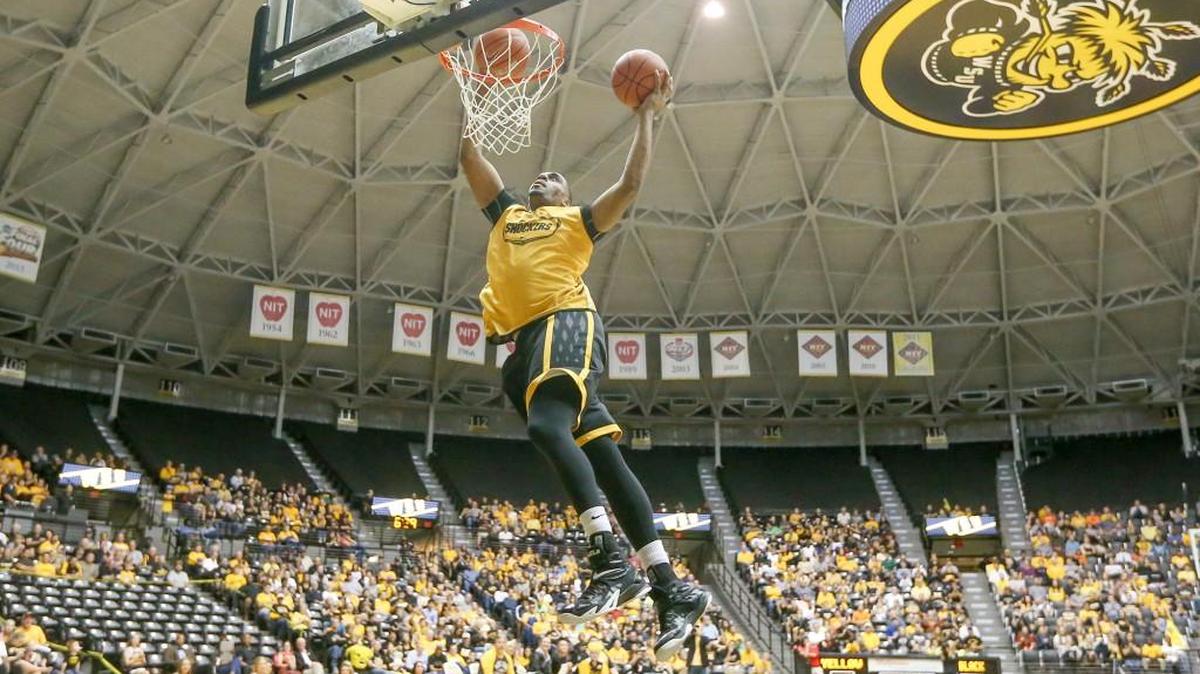 
Wichita State's Darius Carter dunks two balls as he wins the dunk contest during Shocker Madness last October.
