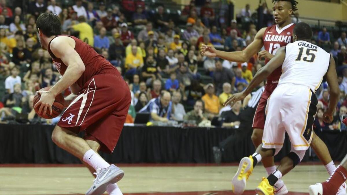 Wichita State forward Anton Grady collides with Alabama guard Dazon Ingram during the second half of their game Friday in Orlando, Fla. Grady went down after the collision and was taken off the court on a stretcher, suffering a spinal concussion.