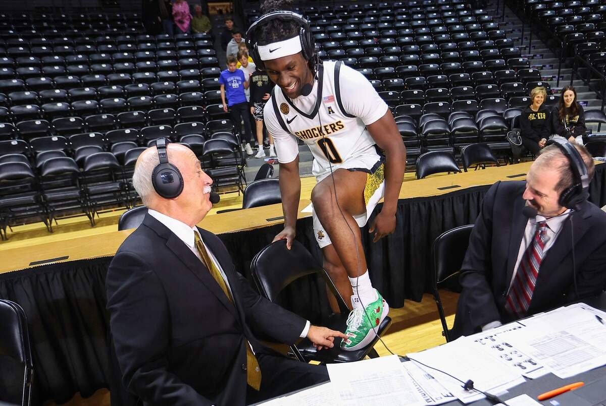 Wichita State senior Karon Boyd shows off his custom-made shoes to the WSU broadcast team of Bob Hull (left) and Shane Dennis (right) following his career-high 22 points in a 88-57 rout of Eastern Kentucky on Sunday.