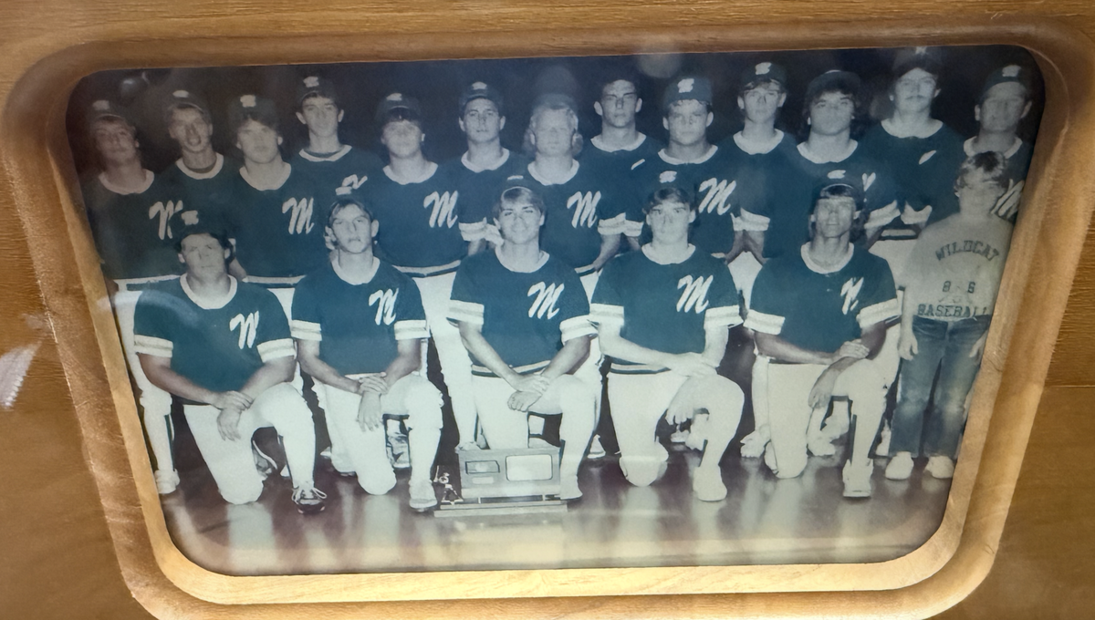 The 1986 Mulvane baseball team poses with its Class 4-1A state championship trophy after winning the program’s first state title. Current Mulvane coach Steve Nelson, wearing jeans on the far right, was the team’s bat boy as a fifth-grader.