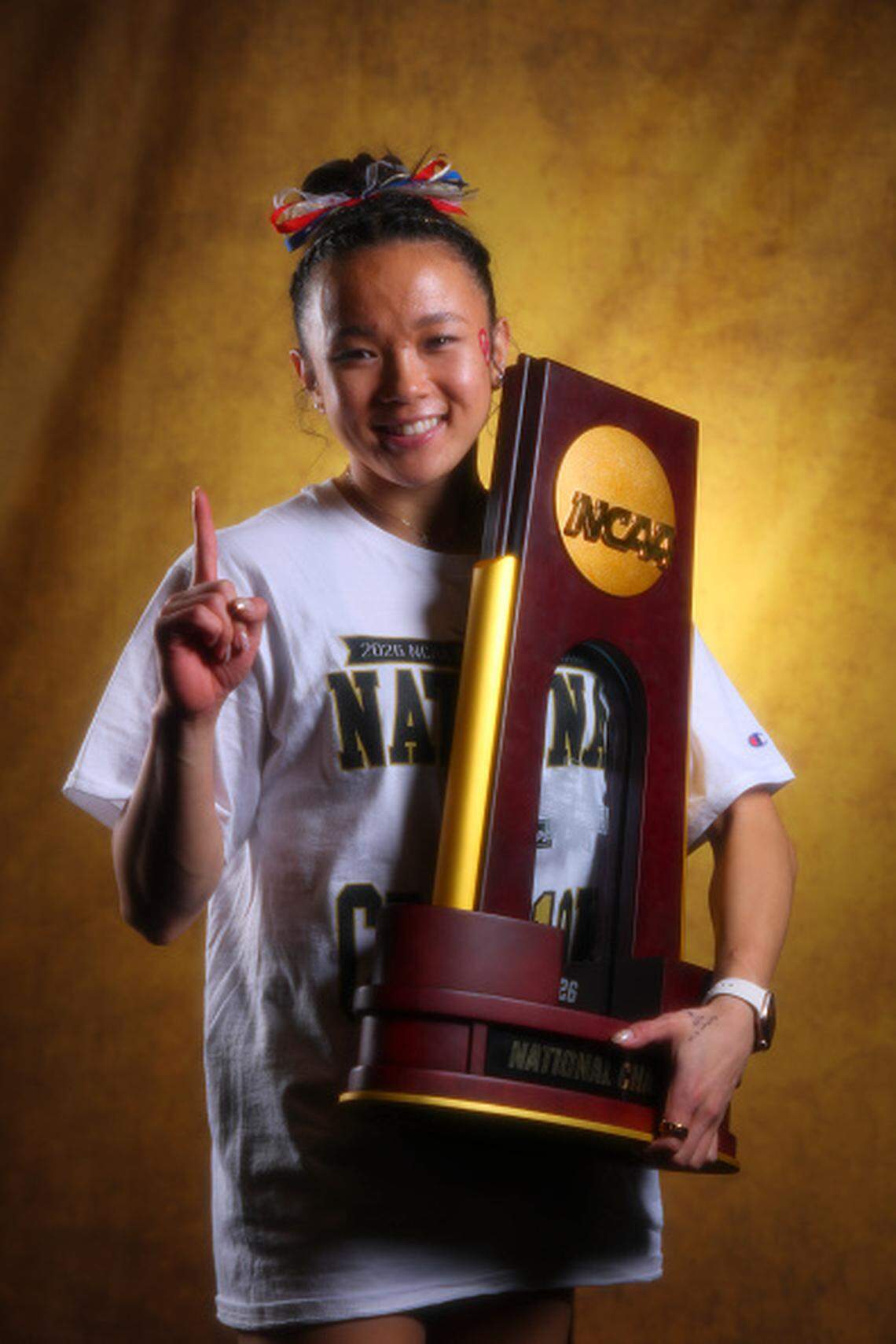 Keira Wells, a 2023 Augusta graduate, poses with the national championship trophy after helping the Oklahoma women’s gymnastics team win its second straight title.