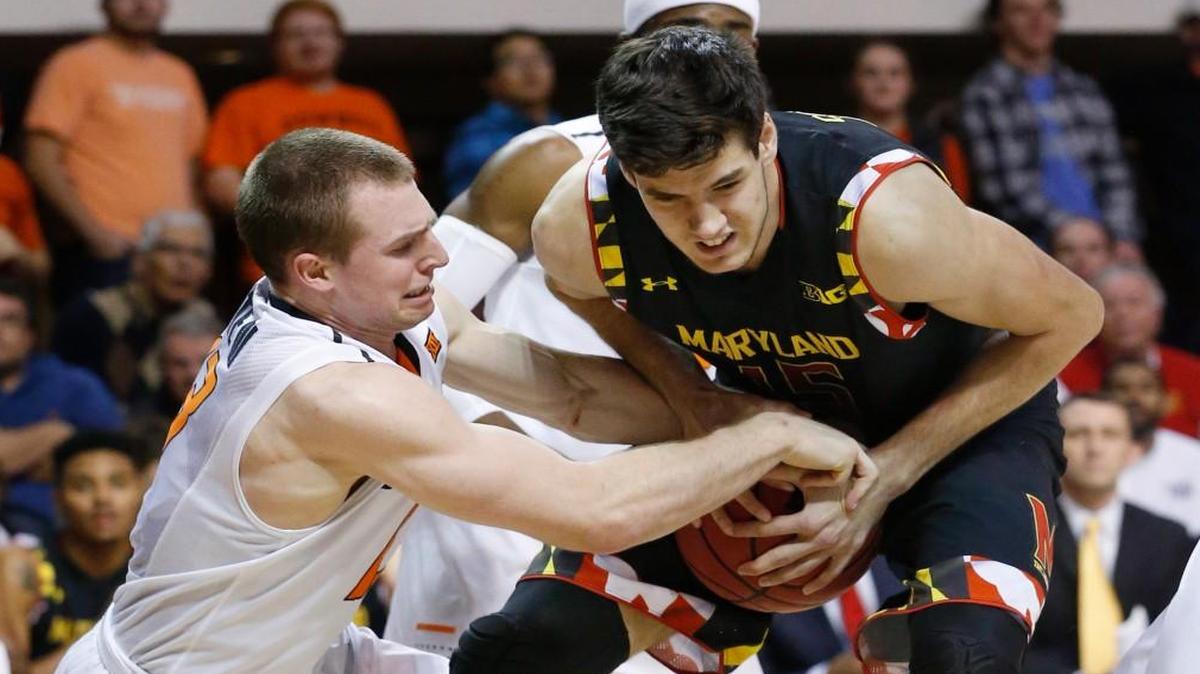 Oklahoma State guard Phil Forte, left, reaches in to grab the ball held by Maryland forward Michal Cekovsky, right, during an NCAA college basketball game in Stillwater, Okla., Sunday, Dec. 21, 2014. Maryland won 73-64.