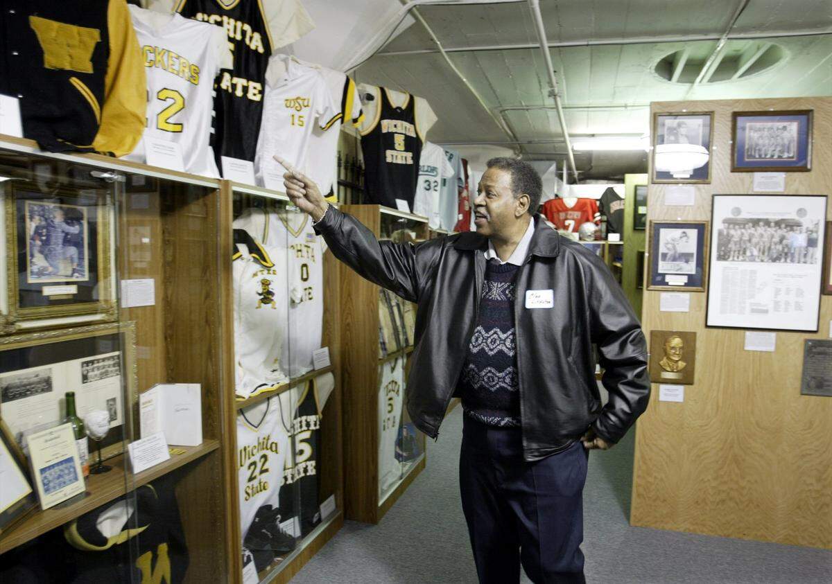 Wichita State legend Cleo Littleton looks over a display of Shocker memorabilia at the Wichita Sports Hall of Fame. Littleton’s No. 13 jersey hangs in the rafters at Koch Arena, and he remains WSU’s career scoring leader with 2,164 points.