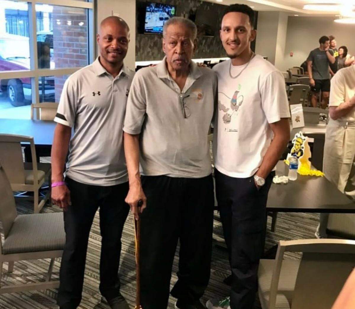 Wichita State legend Cleo Littleton, the first Black player in program history, poses with then-WSU head coach Isaac Brown, the first Black head coach in program history, and former Shocker standout Landry Shamet during a 2021 gathering at Koch Arena. Littleton was especially proud to see Brown lead the program decades after he helped break barriers for Black players at WSU.