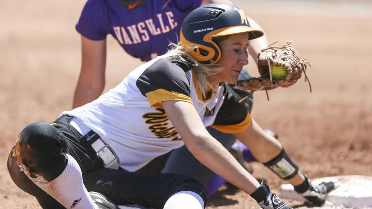Wichita State’s Kennedy Long is tagged out at third base by Evansville’s Susan Norris during the second inning of their game at Wichita State on Saturday.