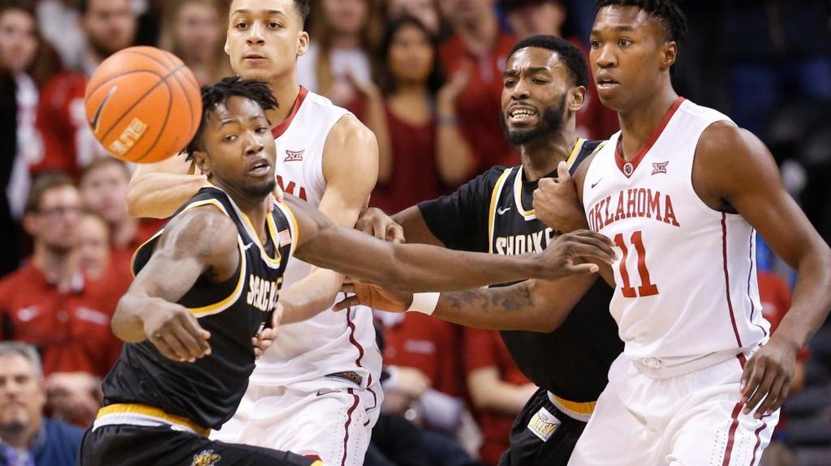 Wichita State’s Zach Brown, left, and Rashard Kelly fight for the ball with Oklahoma’s Kristian Doolittle (11) and Jamuni McNeace in the first half of the two teams’ game last year in Oklahoma City.