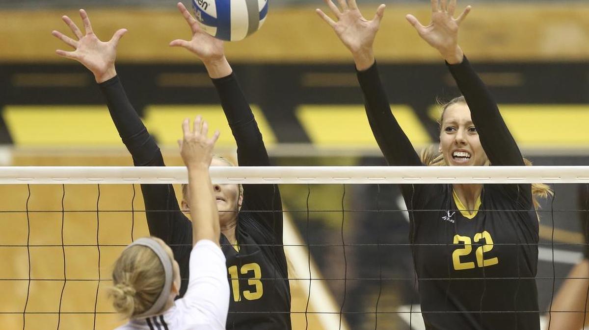 
Wichita State volleyball players Emily Hiebert, left, and Abbie Lehman try to block the shot of Texas State’s Kelsey Weynand during their match on Saturday at Koch Arena. 
