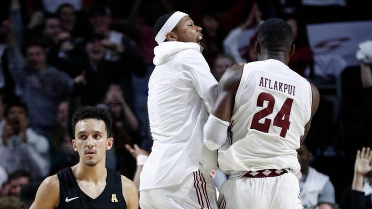 Wichita State's Landry Shamet, left, looks away as Temple players celebrate after the Owls’ overtime two weeks ago in Philadelphia.