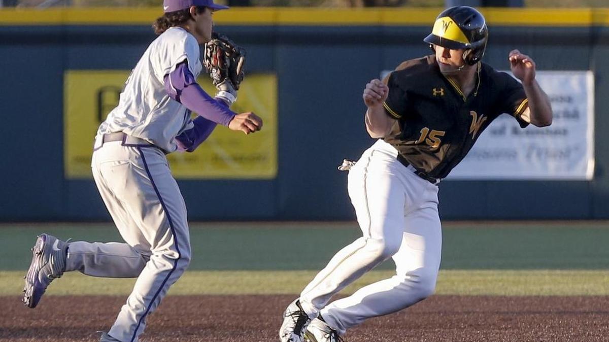 Wichita State’s Zach Reding, right, gets chased down by TCU third baseman Elliott Barzilli in the third inning at Eck Stadium on Friday.