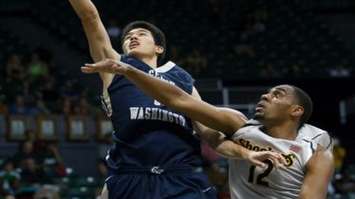 
George Washington forward Yuta Watanabe shoots a layup while being defended by Wichita State forward Darius Carter on Thursday. 
