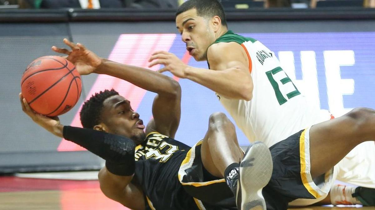 Wichita State forward Markis McDuffie comes up with a loose ball against Miami guard Angel Rodriguez during the first half at Dunkin Donuts Arena on Saturday.