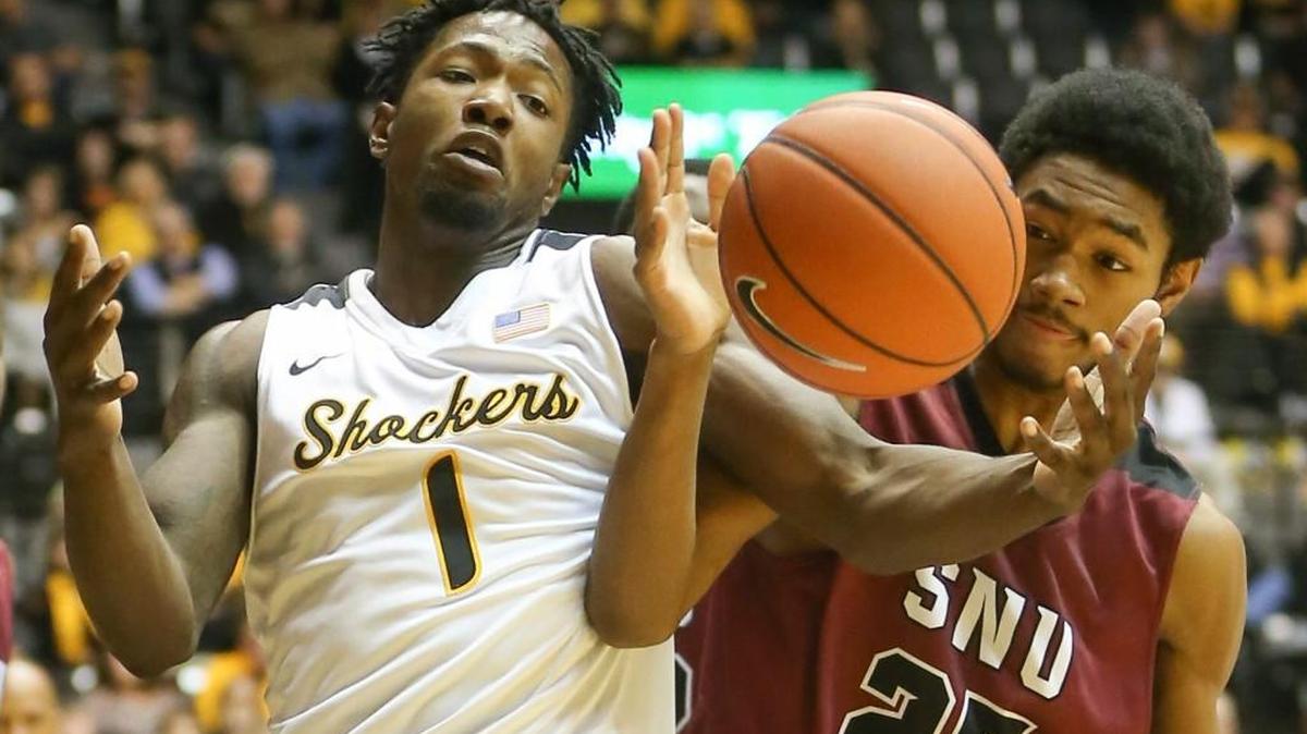 Wichita State's Zach Brown, left, fights for a rebound against Southern Nazarene's Jhonathan Dunn on Nov. 29.