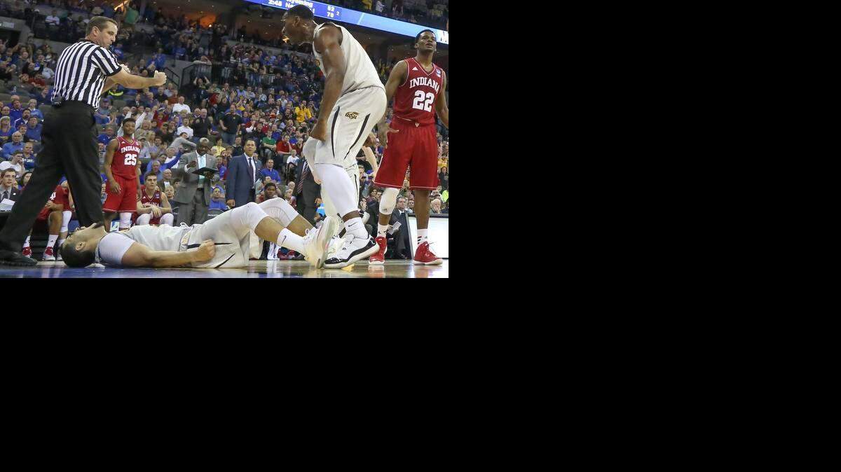 
Wichita State's Fred VanVleet lays on the court and yells after getting a basket and a foul against Indiana during the first half of their game in Omaha on Friday.

