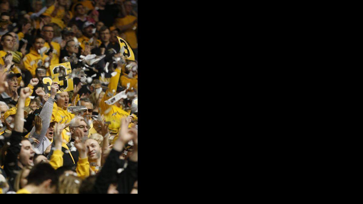 
The Wichita State crowd throws ripped newspaper into the air after the first basket is scored by Fred VanVleet against Evansville on Sunday. 
