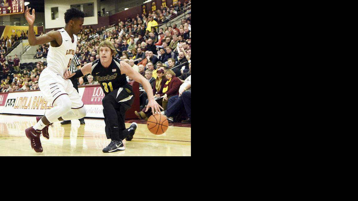 
Wichita State guard Ron Baker (31) is defended by Loyola of Chicago guard Donte Ingram (0) during the first half of an NCAA college basketball game in Chicago, Sunday, Jan. 11, 2015. (AP Photo/David Banks) 
