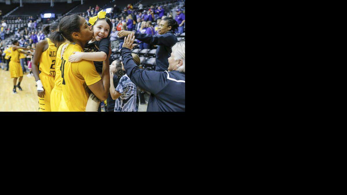 
Wichita State's Alex Harden kisses 4-year-old Ruby Rebolledo after Harden scored 22 points to help the Shockers beat undefeated Kansas State in December.
