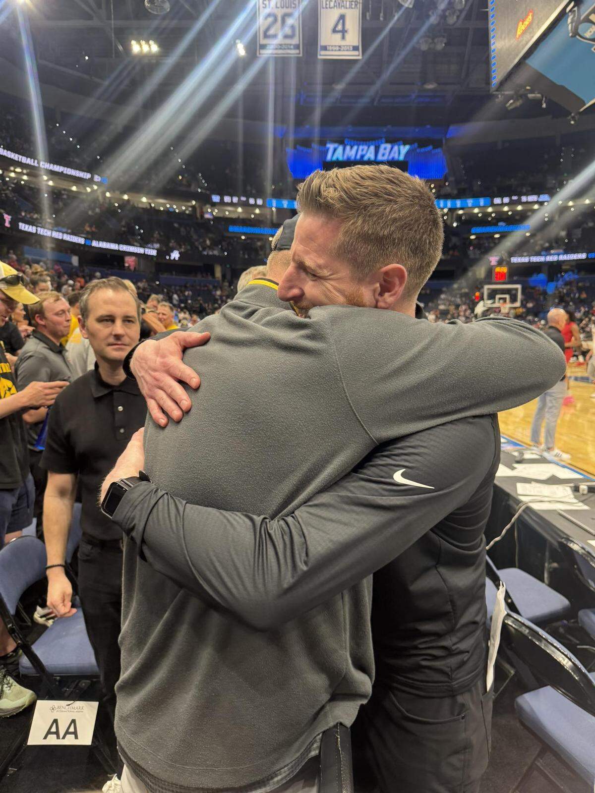 Iowa assistant coach Luke Barnwell and his brother, Cyle, hug after the Hawkeyes’ riveting 73-72 win over No. 1 seed Florida, less than three weeks after their father passed away.