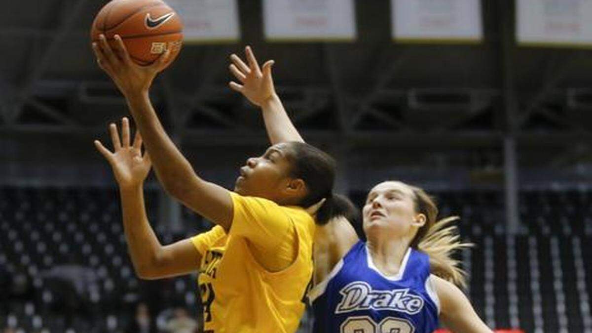 
Wichita State's Alex Harden goes to the basket against Drake's Caitlin Ingle during the first half of their game Friday at Koch Arena.
