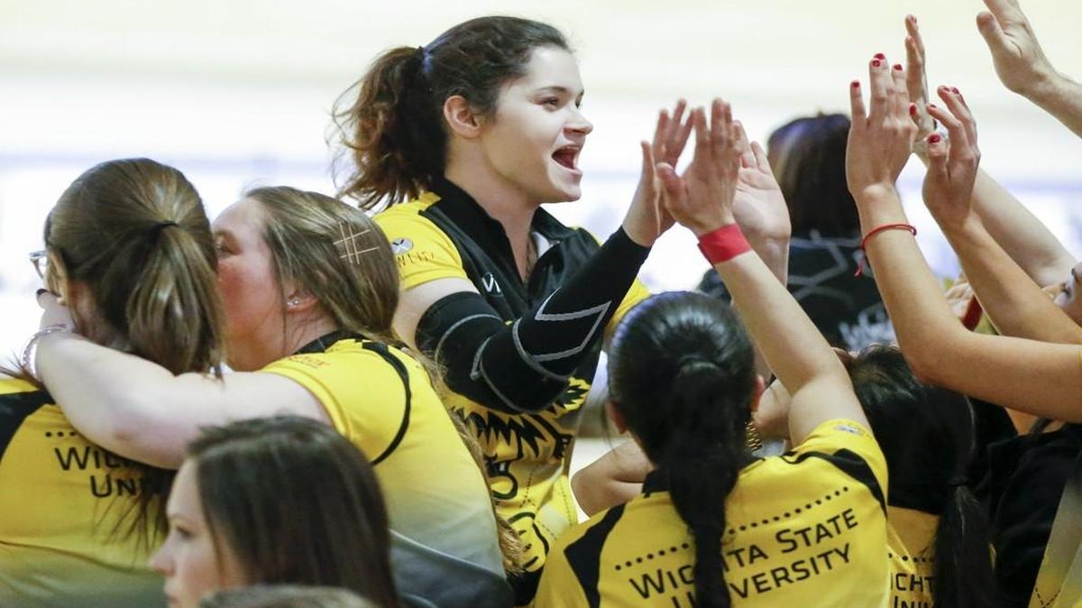 Wichita State senior Daria Kovalova, center, celebrates with teammates after a strike during their match with Wright State at the Bowling's Intercollegiate Team Championships at Northrock Lanes Thursday. The Wichita State women won both their matches to advance to Friday’s winners bracket semifinals.