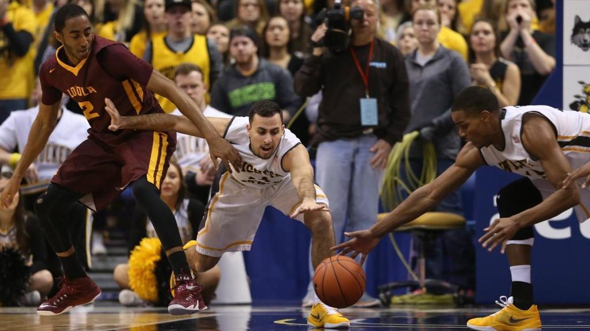 Wichita State guard John Robert Simon goes after a loose ball against Loyola guard Earl Peterson.