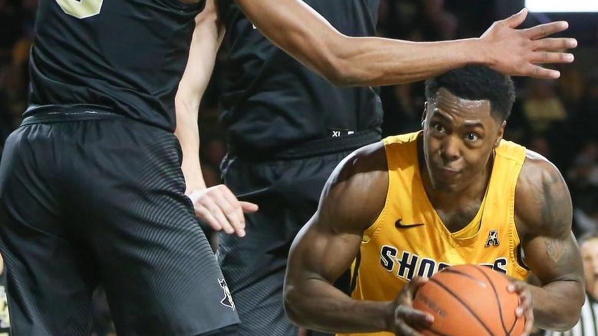 Wichita State senior Darral Willis Jr. tries to go up for a shot while Central Florida’s A.J. Davis, left, and Rokas Ulvydas defend during the first half Thursday at Koch Arena.