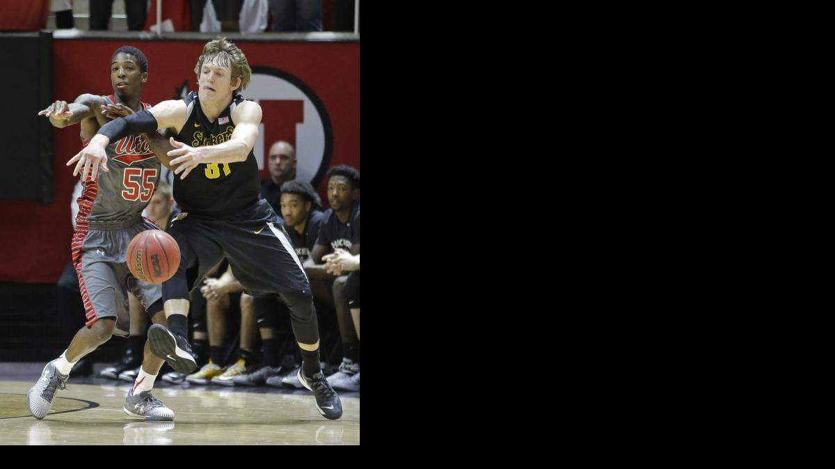 
Utah guard Delon Wright (55) and Wichita State guard Ron Baker (31) battle for a loose ball in the second half during an NCAA college basketball game Wednesday, Dec. 3, 2014, in Salt Lake City. (AP Photo/Rick Bowmer) 
