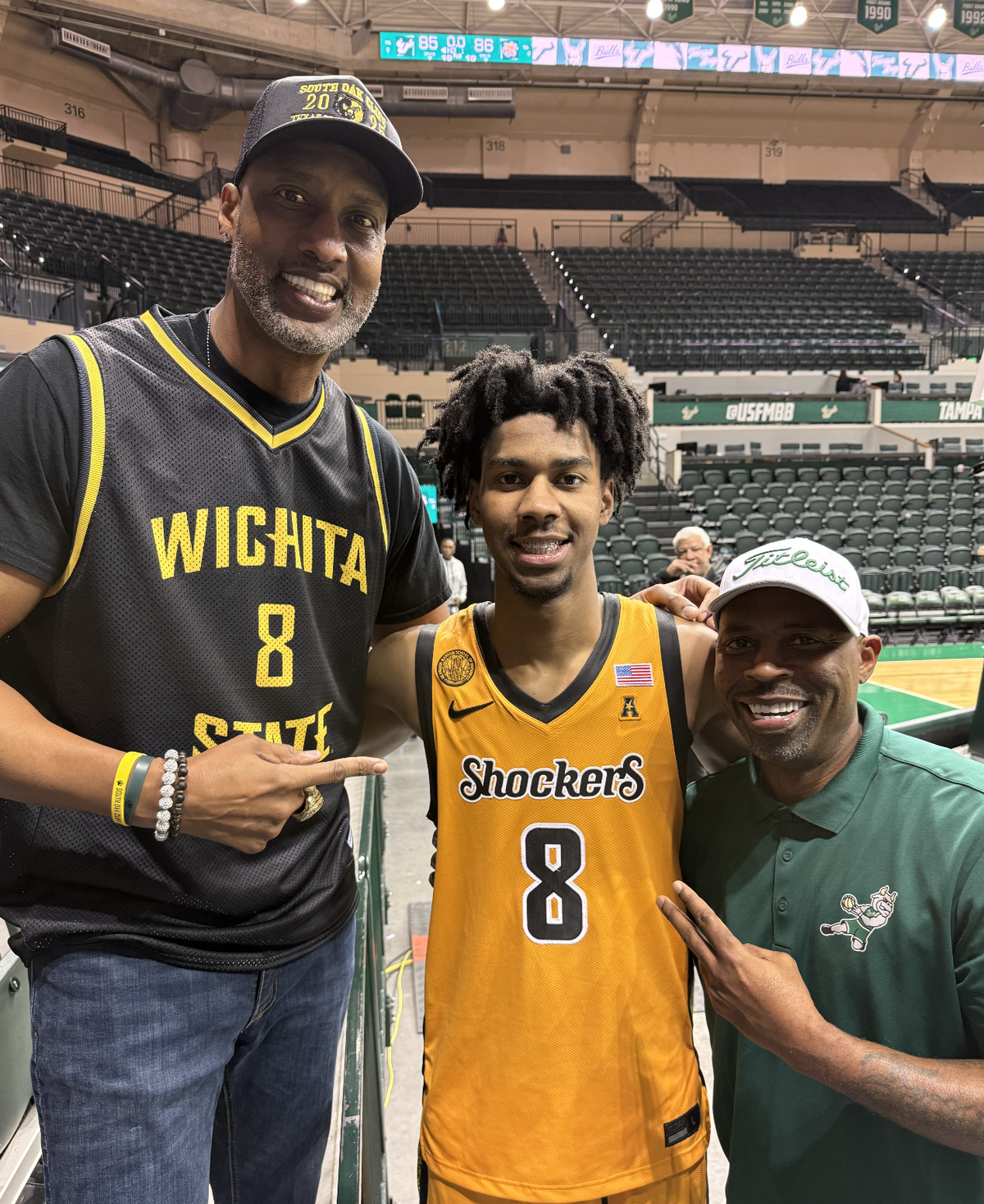 Derrick Battie, left, and Dillon Battie, center, pose for a picture with former NBA player Chucky Atkins after Wichita State’s road game at South Florida earlier this season.