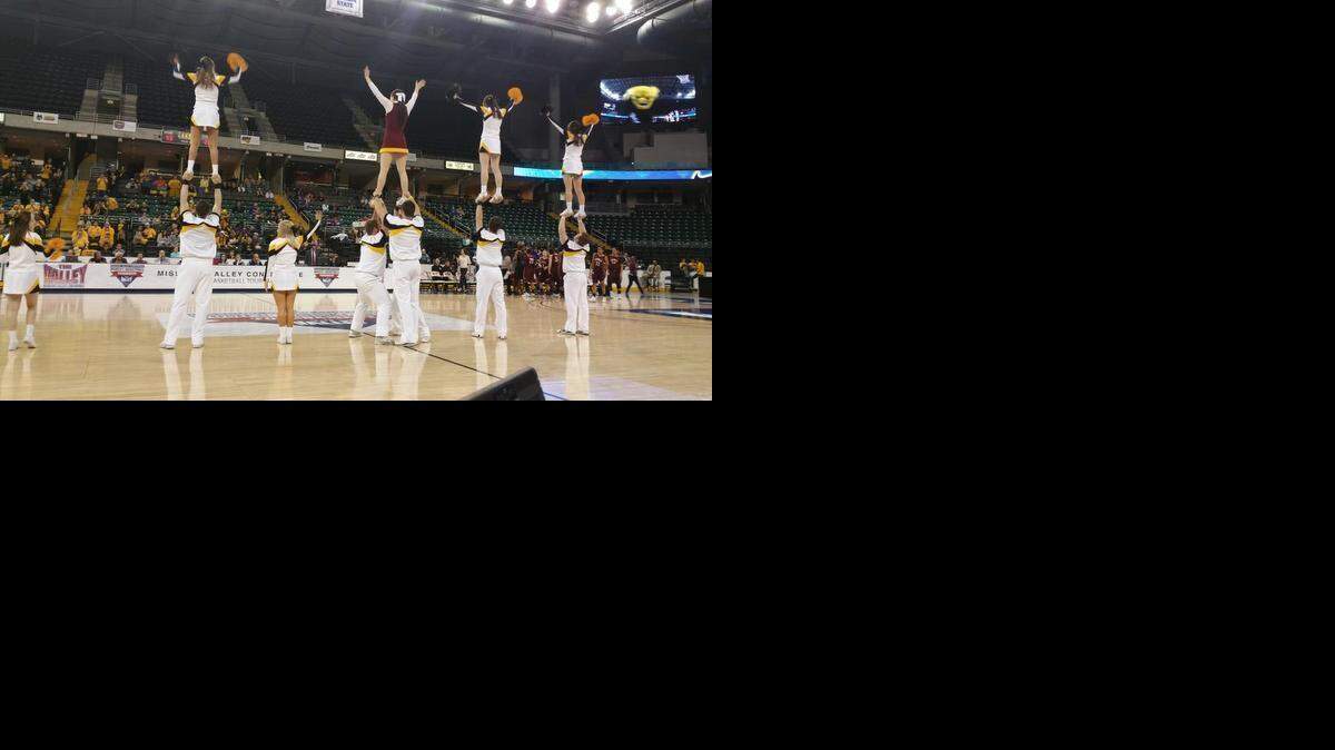 
Loyola cheerleader Maddie Kenney, center top, joined Wichita State cheerleaders at timeouts during the Shockers’ 59-42 win over Loyola in the Missouri Valley Conference women’s basketball tournament Friday in St. Charles, Mo.
