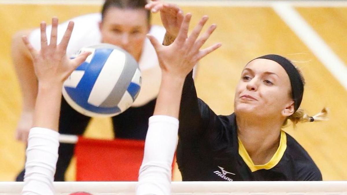 
Wichita State's Shimen Fayad, right, spikes the ball against Northern Illinois on Sept. 10.

