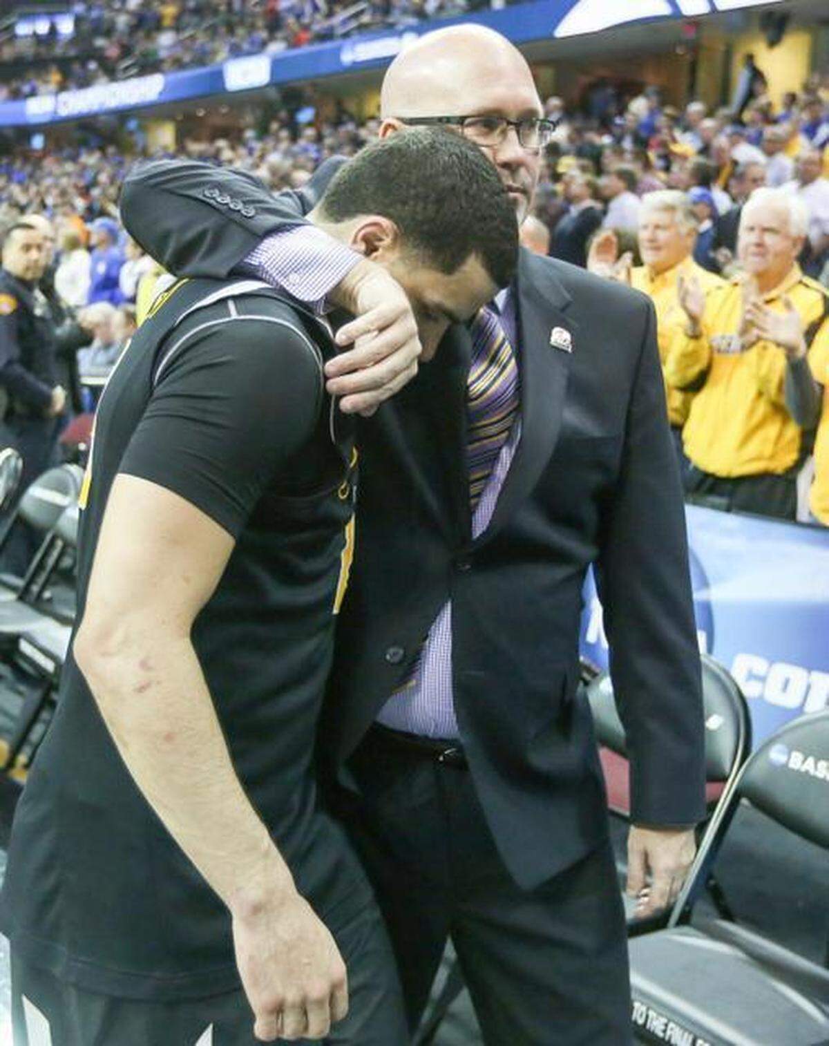 Wichita State guard Fred VanVleet walks off the court with assistant coach Steve Forbes after the Shockers were defeated by Notre Dame 81-70 on Thursday.
