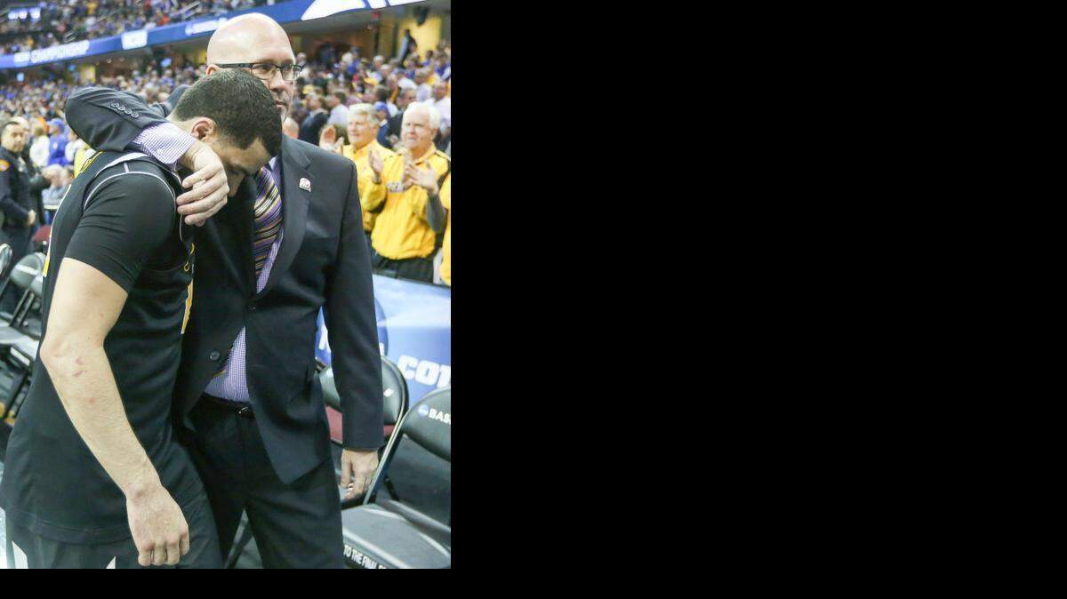 
Wichita State guard Fred VanVleet walks off the court with assistant coach Steve Forbes after the Shockers were defeated by Notre Dame 81-70 on Thursday.
