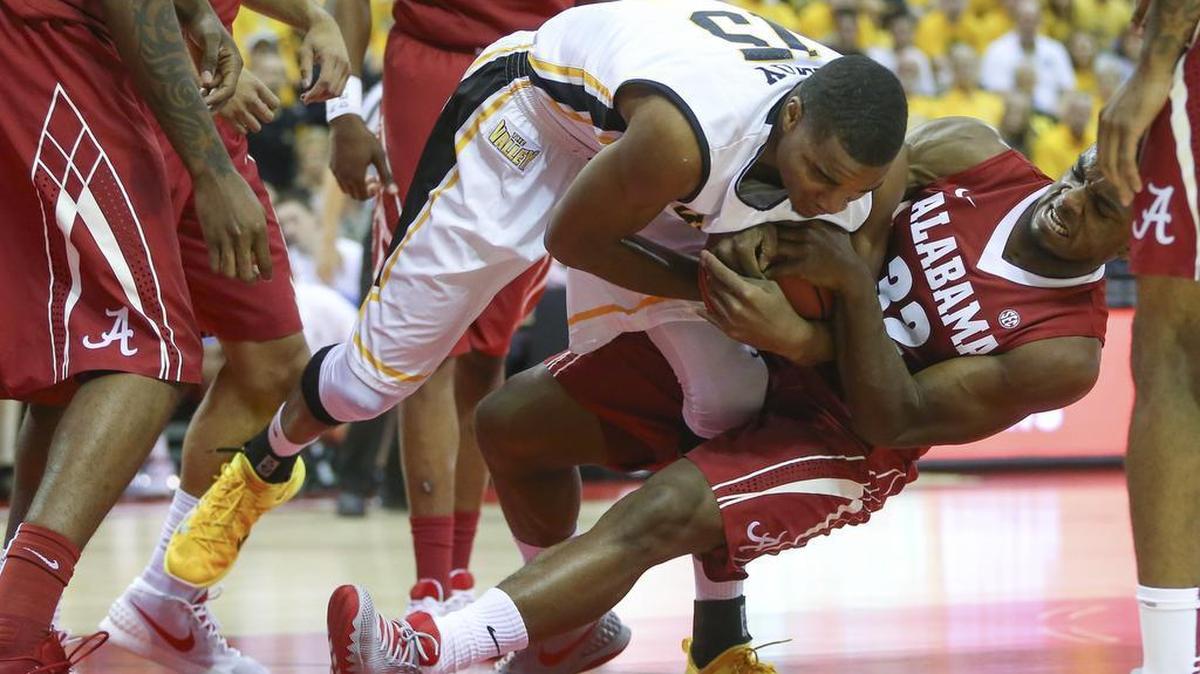 Wichita State forward Anton Grady gets tangled up against Alabama guard Retin Obasohan during the first half of their game at the AdvoCare Invitational in Orlando on Friday. (Nov. 27, 2015)